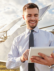 cheerful businessman using tablet solar farm 1