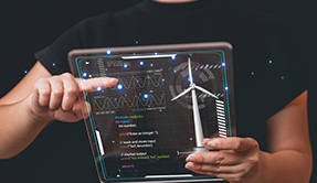 man holding tablet computer with wind turbines screen renewable energy concept 1